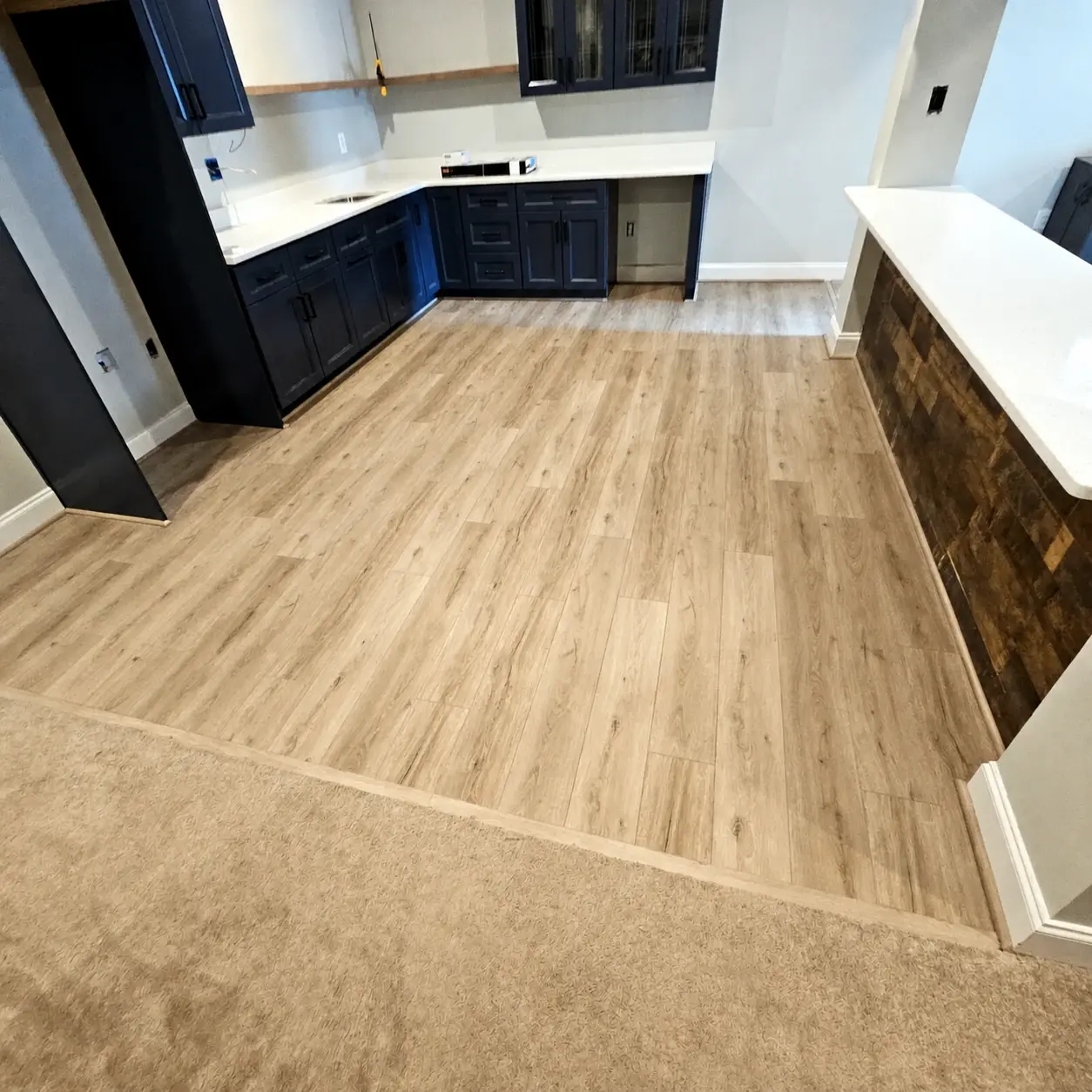Finished kitchen flooring with a clean transition into the surrounding room